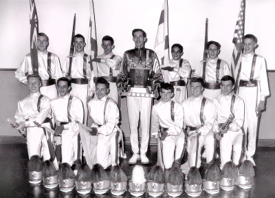 The 1961 Junior National Colour Guard Champions of Canada, with Captain Thomas Kelly holding the trophy. 
Front row, left to right, John Walsh, Michael McCullough, Adam Vereshack, Paul Sullivan, Robert Rowan, Patrick Sullivan. 
Back row, left to right, Kevin Moloney, Anthony Cornper, John Burns, Captain Torn Kelly, Leonard Altilia, Lawrence Smith and Michael Boland
Keywords: 1961